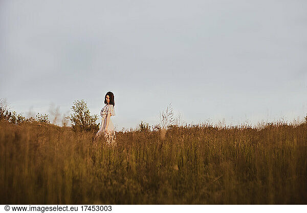 Girl walk in grass summer countryside field