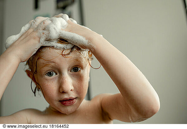 Girl washing hair in bathroom