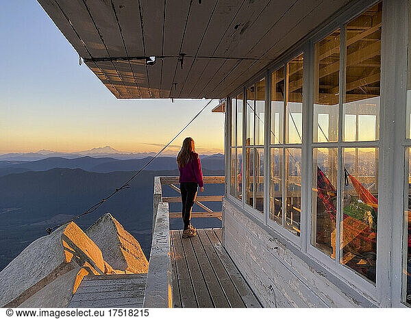 Girl watching sunrise at Mount Pilchuck in the North Cascades