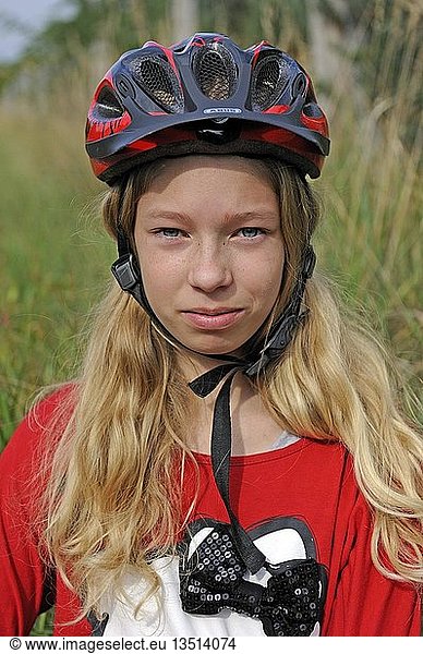 Girl  11  wearing a bicycle helmet