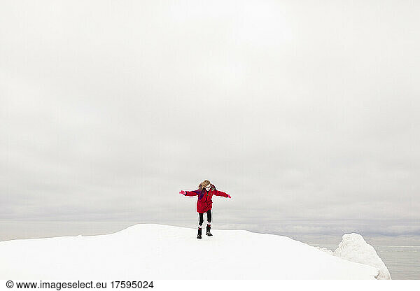 Girl with arms outstretched enjoying in winter