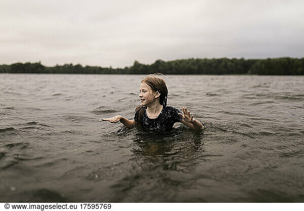 Girl with brown hair swimming in lake