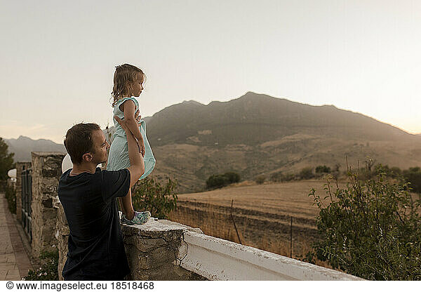Girl with father enjoying sunset