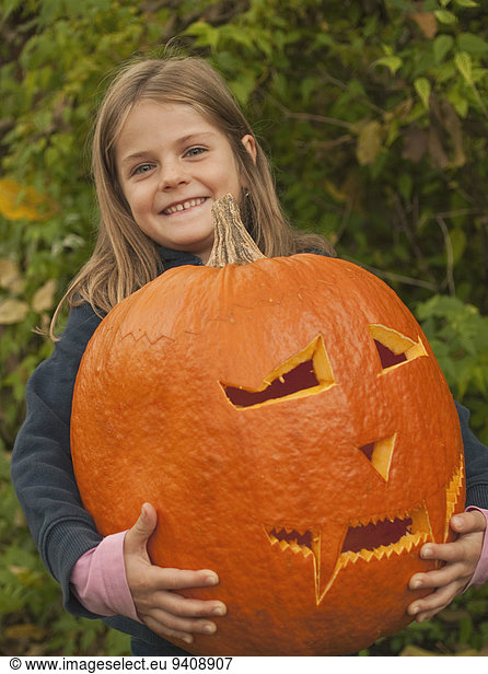 Girl with halloween lantern  smiling  portrait