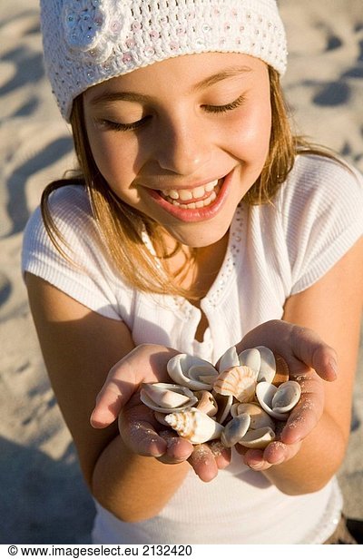 Girl with handsful of seashells