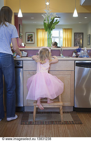 Girl with her mother in the kitchen of a disability accessible home