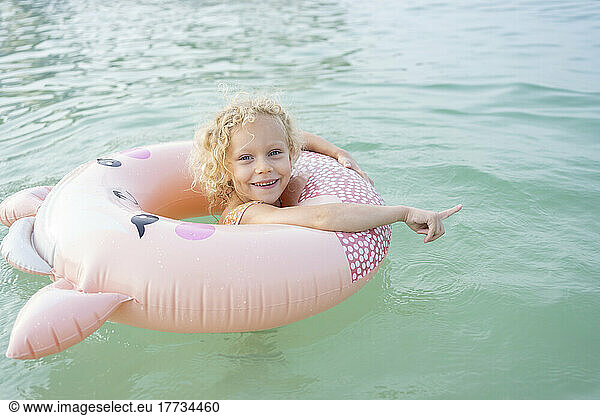 Girl with inflatable ring swimming in sea