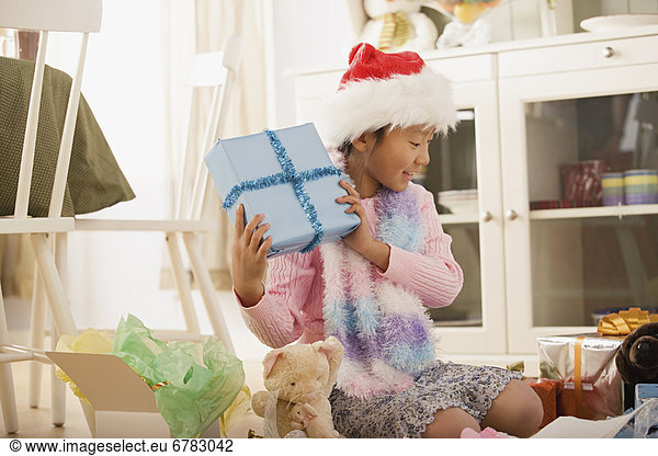 Girl with presents at Christmas morning