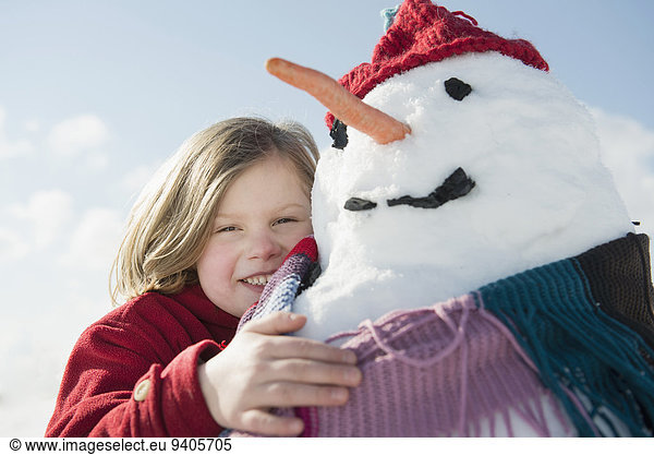 Girl with snowman  smiling