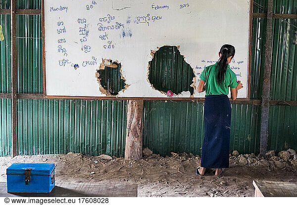 Girl writes in English and Khmer on the board at The Green School in Kampong Tralach Village  Cambodia; Kampong Tralach District  Cambodia