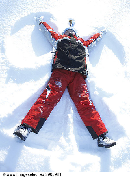 Girl  10 years old  in the snow  making snow angels