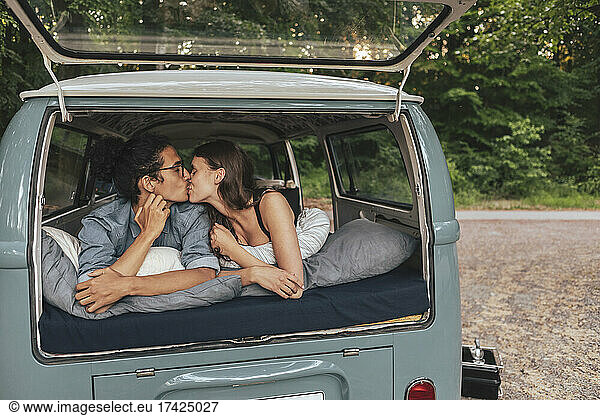 Girlfriend and boyfriend kissing in van