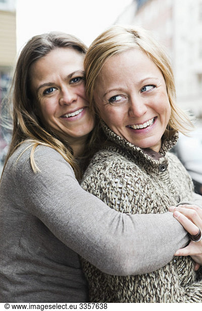 Girlfriends hugging outside