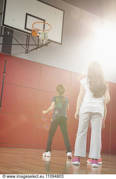 Girls playing basket ball in basketball court,  Munich,  Bavaria,  Germany