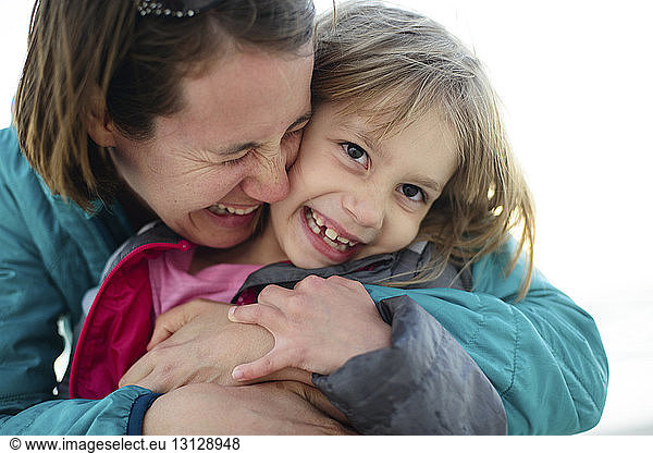Glückliche Mutter umarmt Tochter