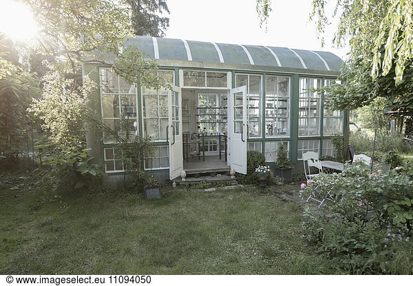 Glass house in garden at daytime  Bavaria  Germany