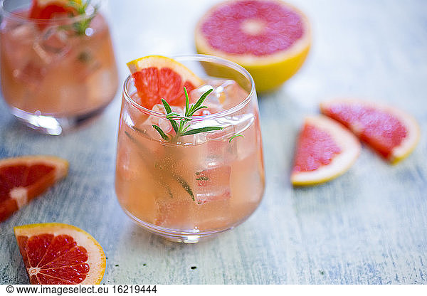 Glass of fresh grapefruit juice and grapefruits