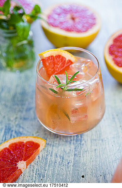 Glass of fresh grapefruit juice and grapefruits
