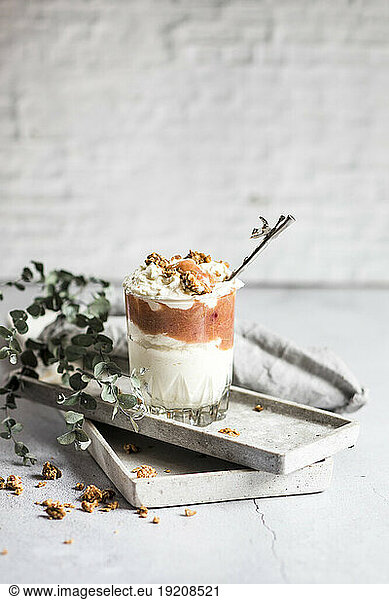 Glass of healthy sugarfree mascarpone dessert with yogurt  rhubarb and granola