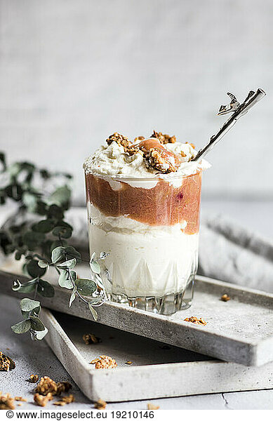 Glass of healthy sugarfree mascarpone dessert with yogurt  rhubarb and granola