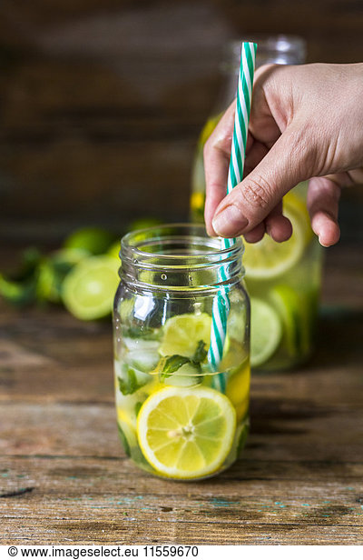 Glass of infused water with lemon  lime  mint leaves and ice cubes