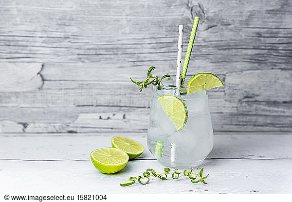 Glass of non-alcoholic tonic with lime and rosemary
