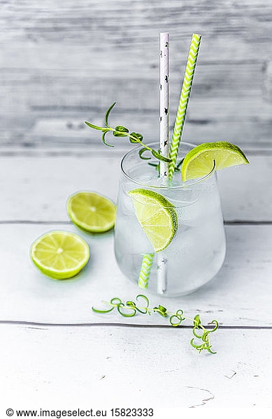 Glass of non-alcoholic tonic with lime and rosemary