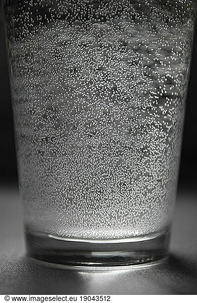 Glass of water with lots of tiny bubbles.