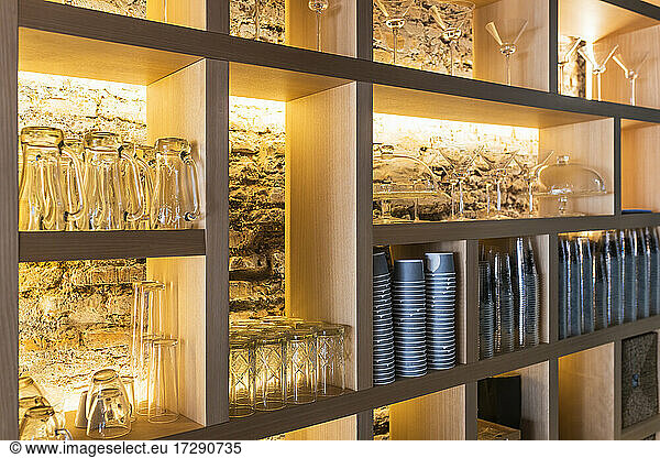 Glasses arranged on shelf in bar