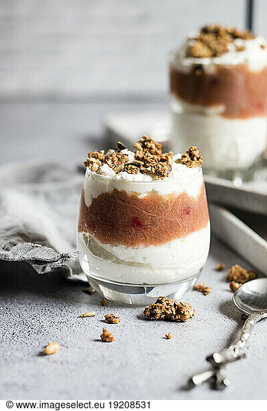 Glasses of healthy sugarfree mascarpone dessert with yogurt  rhubarb and granola