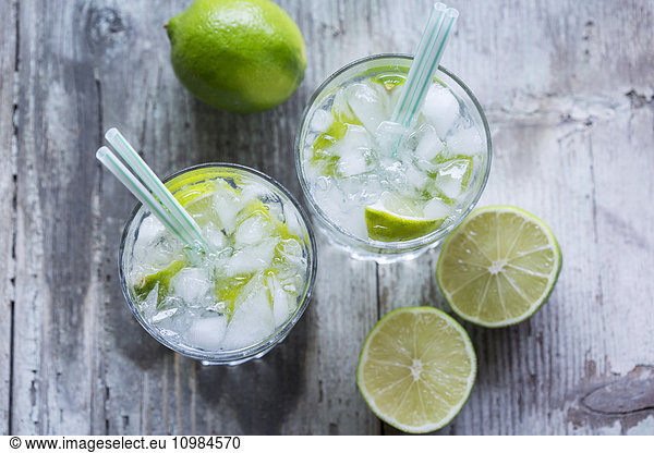 Glasses of infused water with lime and ice cubes