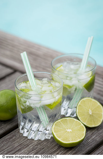 Glasses of infused water with lime and ice cubes