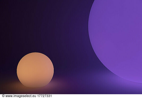 Glowing and illuminated spherical coloured orbs on a black background.
