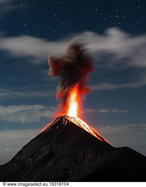 Glowing lava and smoke spitting volcano  volcanic eruption at night  Volcan de Fuego  Guatemala  Central America