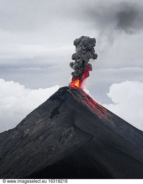 Glowing lava and smoke spitting volcano  volcanic eruption  Volcan de Fuego  Guatemala  Central America