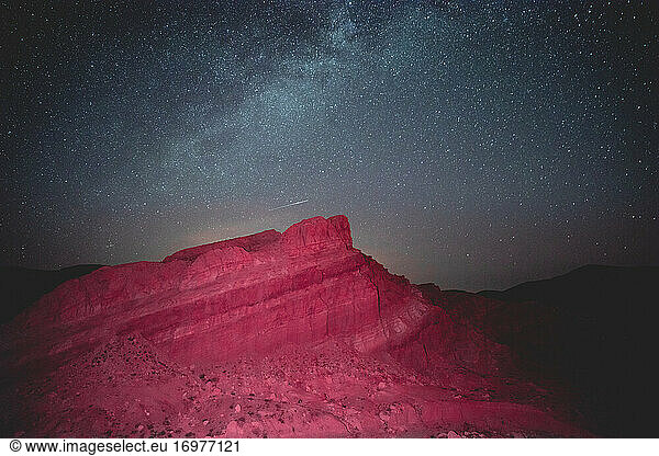 Glowing mountain under starry sky