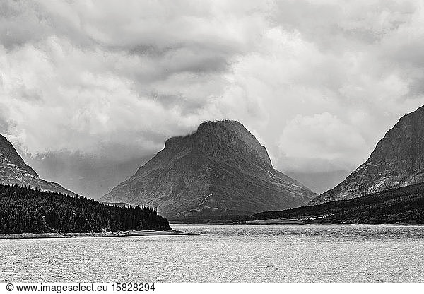 Going to the sun mountain looms over saint mary lake on stormy day