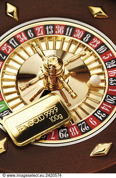 Gold bar on roulette wheel  elevated view