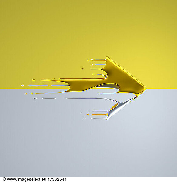 Gold colored liquid arrow flying past yellow and gray background