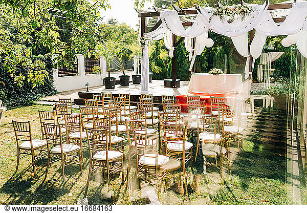 Golden chiavari chairs for outdoor garden wedding