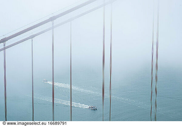 Golden Gate Bridge and two boats in fog