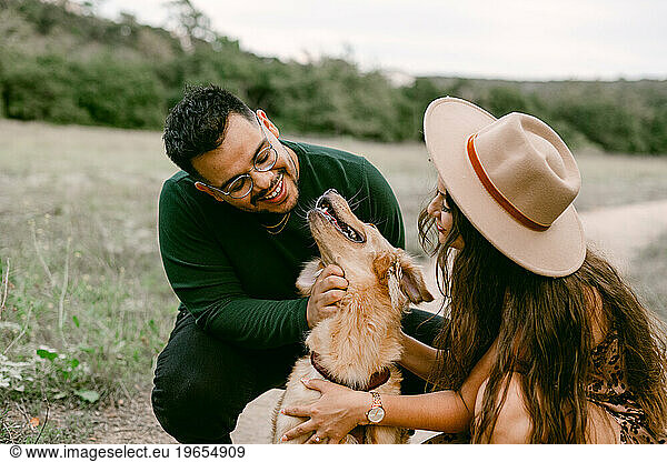 Golden retriever smiling at couple