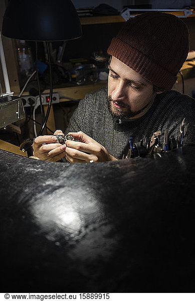 Goldsmith working on ring in his workshop