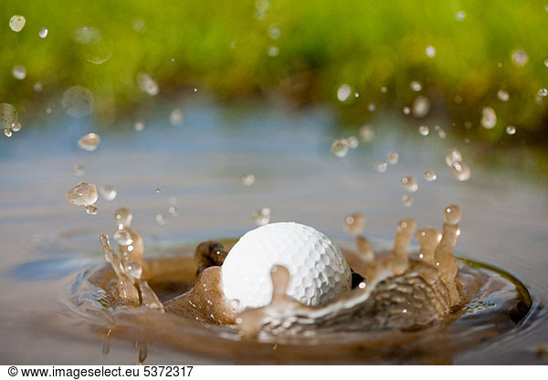 Golf ball splashing into water