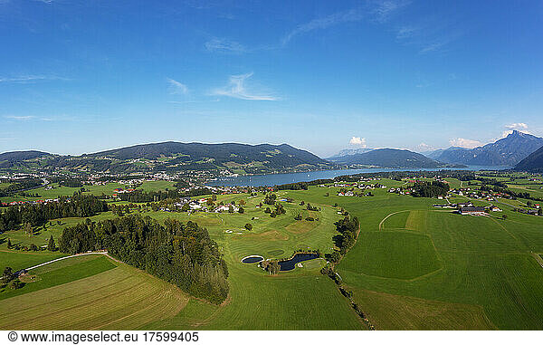Golf course near Lake Mondsee under blue sky on sunny day  Salzkammergut  Upper Austria  Austria