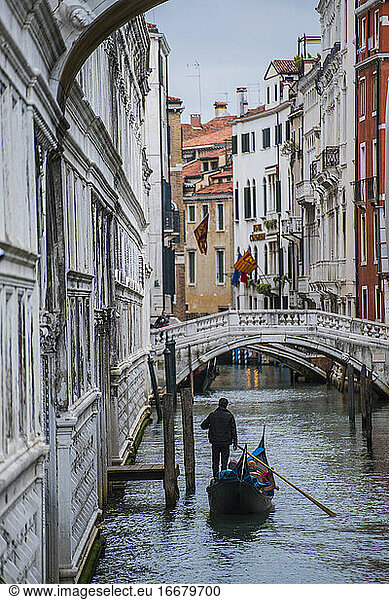 gondola on narrow canal in Venice