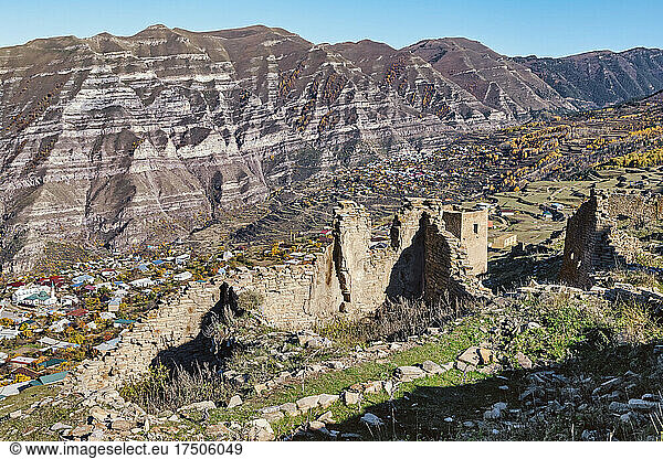 Goorskaya Bashnya near mountain range on sunny day  Dagestan  Russia