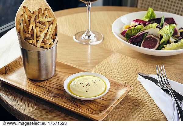 Gourmet French fries with ahi tuna salad.