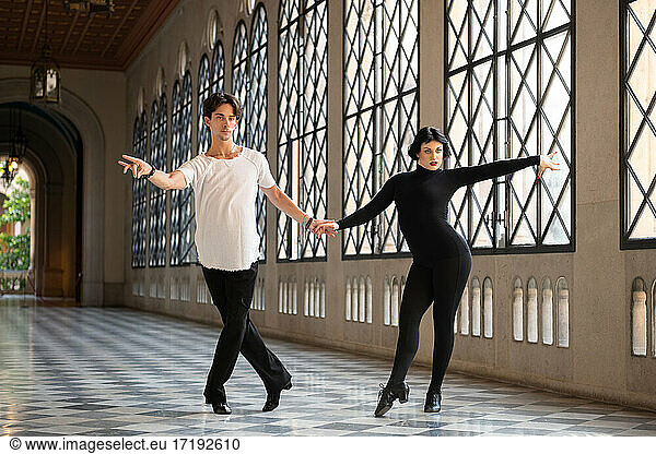 Graceful couple practicing ballroom dance steps