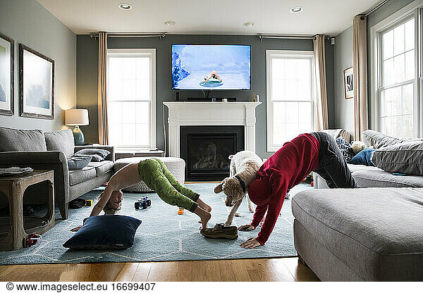 Grade School and Tween Brothers Do Yoga in Their Living Room With Dog